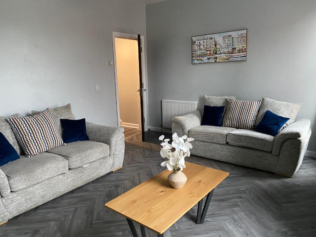 a living room with two couches and a coffee table at Baron Apartment B in Ballymena