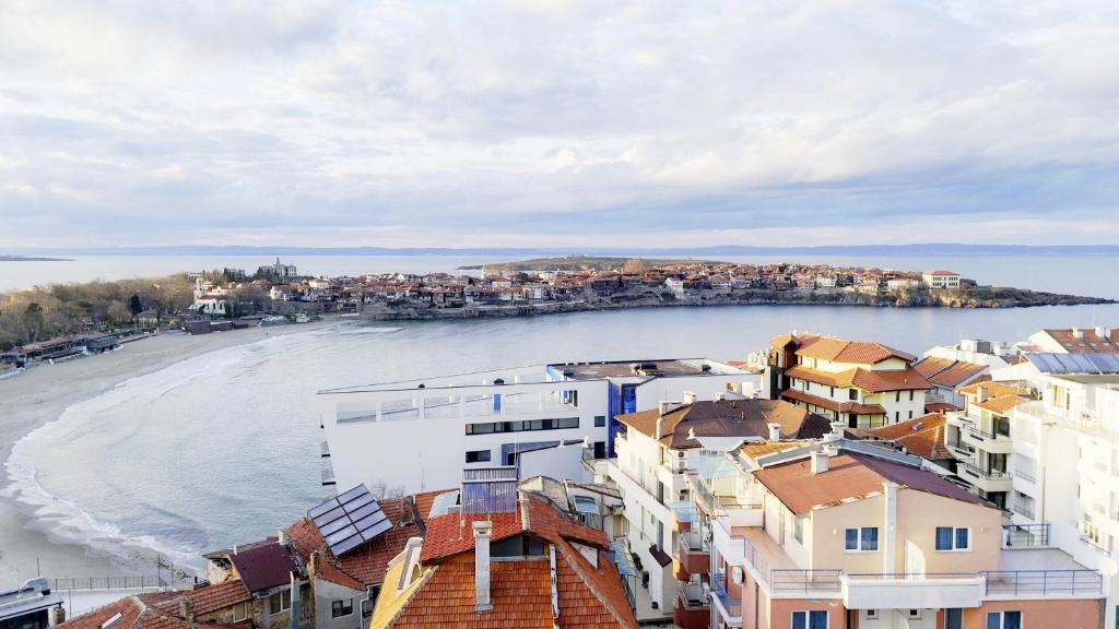 a view of a beach with houses and buildings at Velonia Guest House in Sozopol