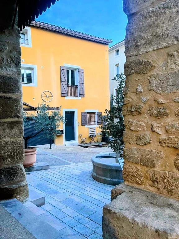 a view of a building from a stone pillar at Caractère de Beaumes in Beaumes-de-Venise