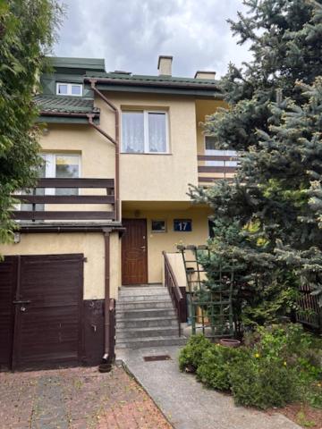 a house with a gate and stairs in front of it at House with garden For 8 people in Suwałki