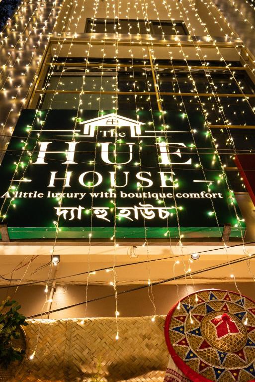a sign on the side of a building with lights at The Hue House in Sibsāgar