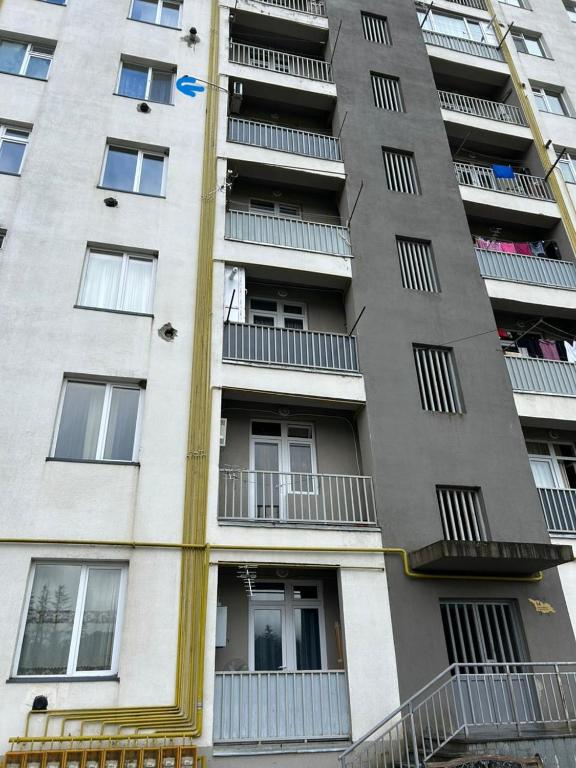 a tall apartment building with balconies on it at Hotel Tamo in Tsqaltubo