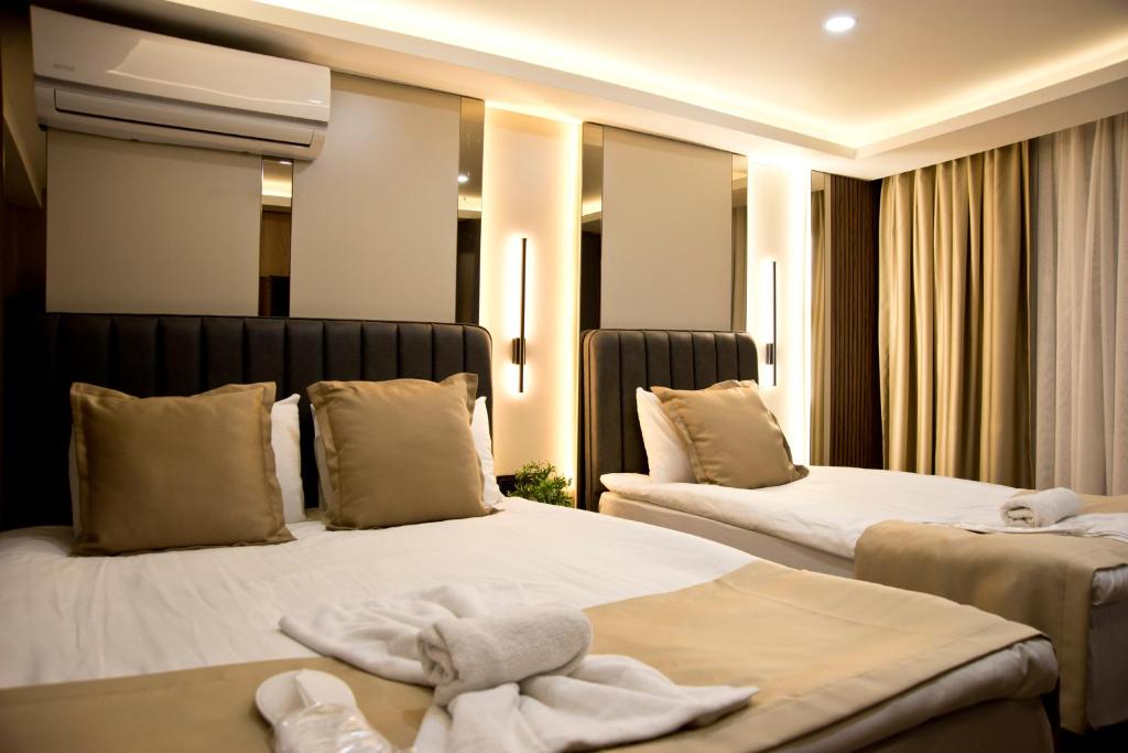 a hotel room with two beds with towels on them at Grand Bagoz Hotel in Istanbul