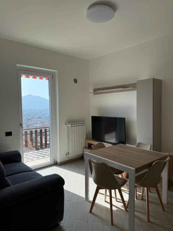 a living room with a table and a couch at La Dimora del Lago d'Iseo in Sarnico