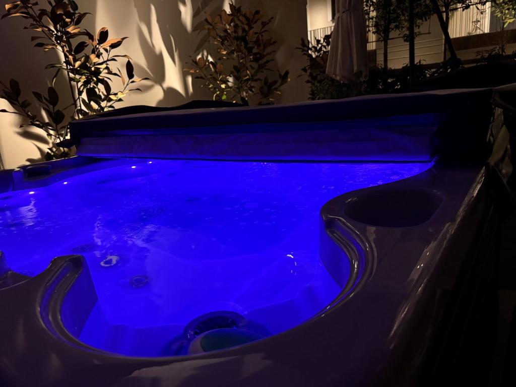 a blue hot tub in a dark room at KaiserLogen Wellness in Kaisersesch