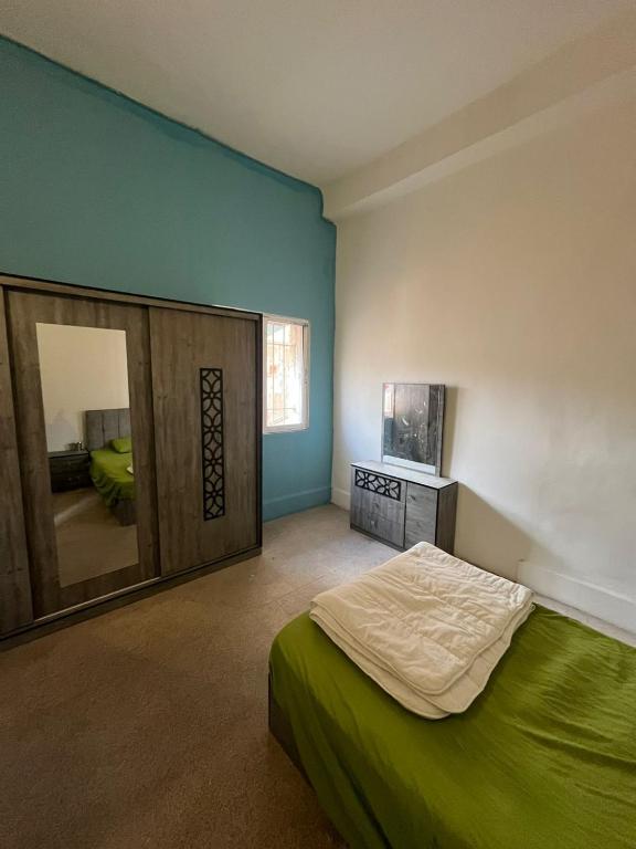 a bedroom with a bed and a large mirror at The Blue House in Amman