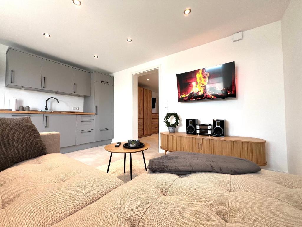 a living room with a couch and a kitchen at An der Grüh in Großsolt