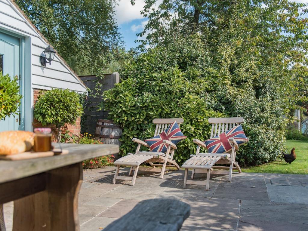 three chairs with british flags sitting on a patio at Freshwater Barn in Benenden