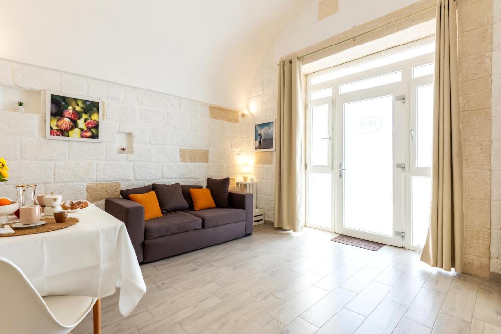 a living room with a couch and a table at Casa Roma 78 Traditional Stone House in Monopoli Center in Monopoli
