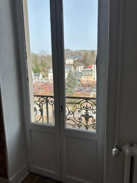 an open door with a view of a city at Appartement 16 Colette in La Bourboule
