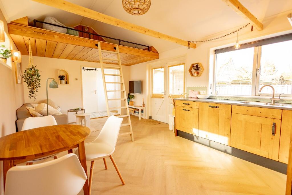 a kitchen with a wooden table and a dining room at Sauke Jaap in Buren