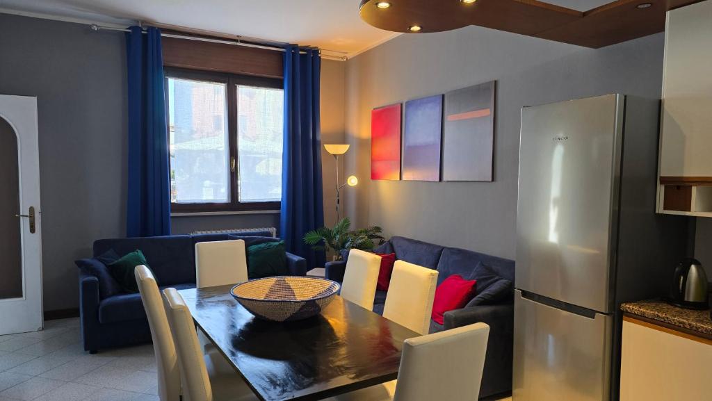 a kitchen and living room with a table and a couch at Terry House in Sirmione