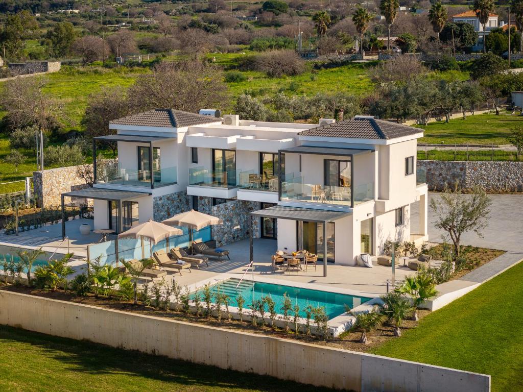 an aerial view of a villa with a swimming pool at Mama Rosa Luxury Villas with private pools in Zipárion
