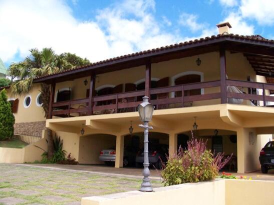 a large apartment building with a balcony and a street light at Casa da Vó Lucia in Serra Negra