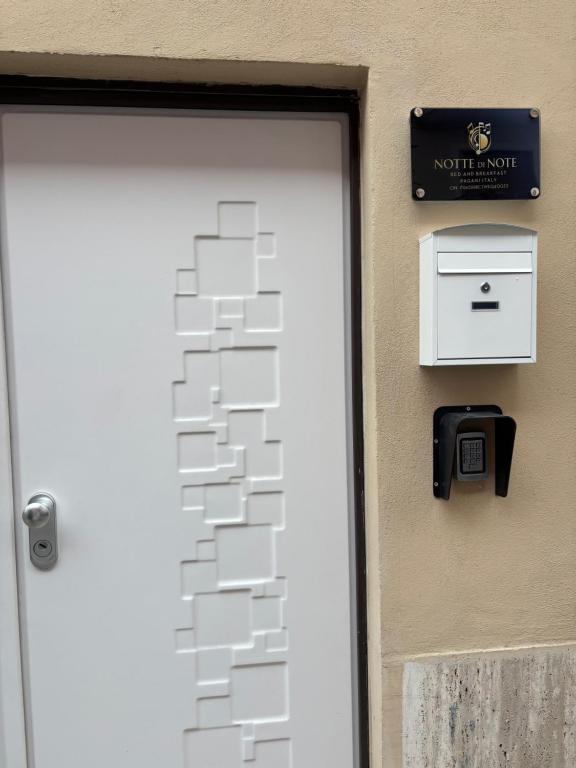 a white door with a mail box next to it at Notte di note in Pagani