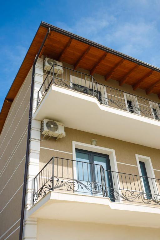 an apartment building with balconies and a balcony at Sunny Breeze Hotel in Vlorë
