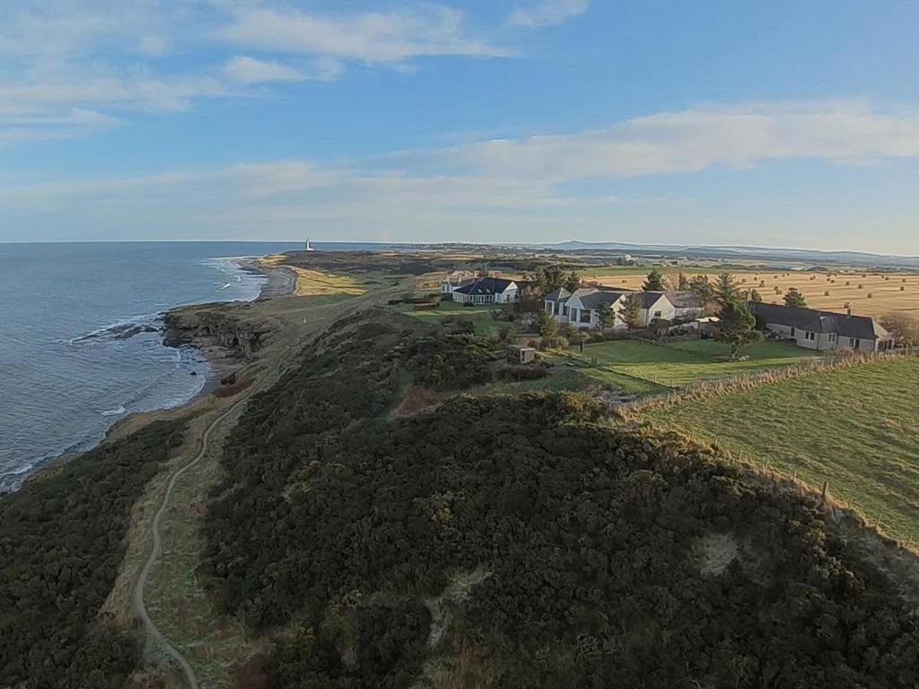 an aerial view of a house next to the ocean at Shelterstone in Elgin