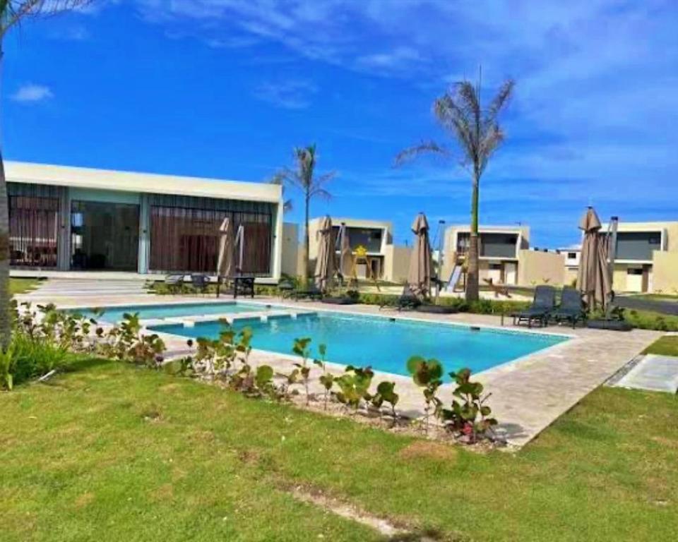 a swimming pool in front of a building at Atabey II – Epic Residence, Bávaro in Punta Cana