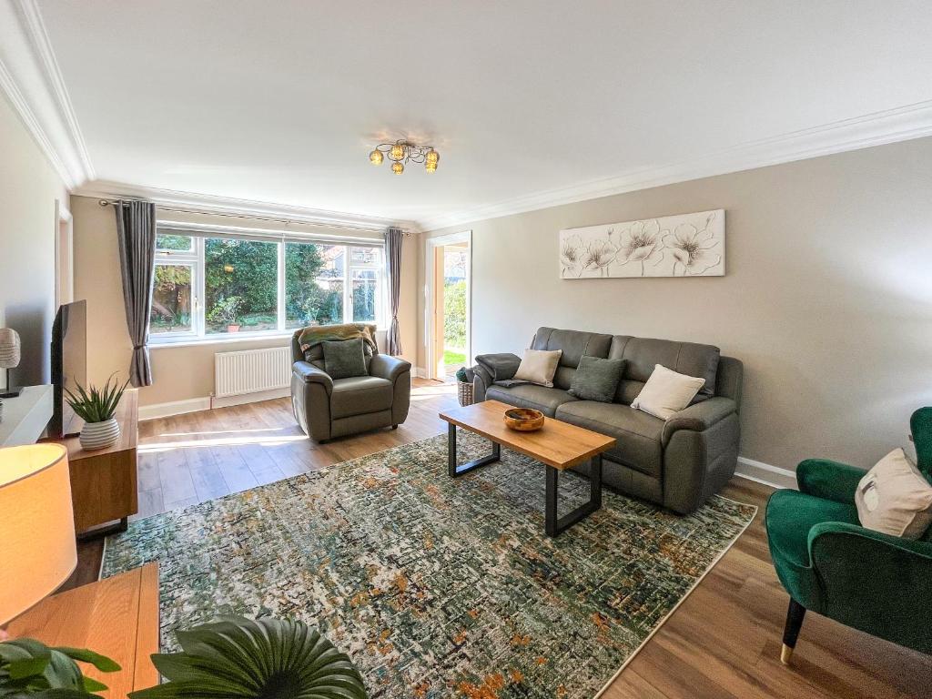 a living room with a couch and a table at Casa Rosa in Prestatyn