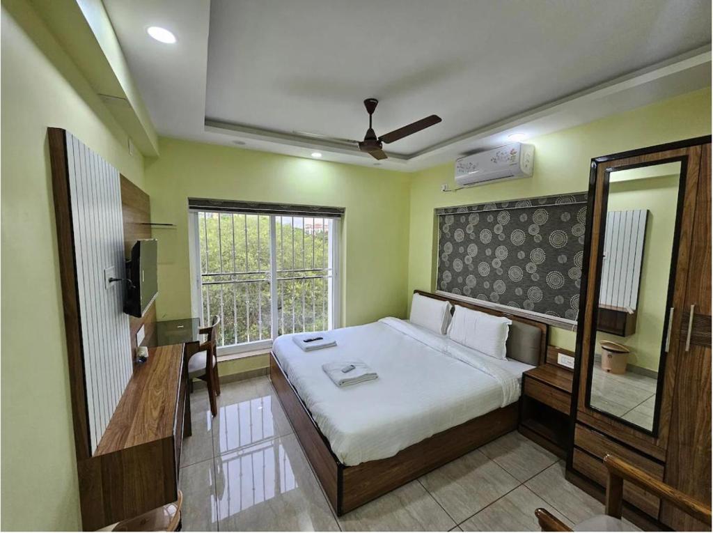 a bedroom with a large bed and a window at V3 Inn Private Limited in kolkata