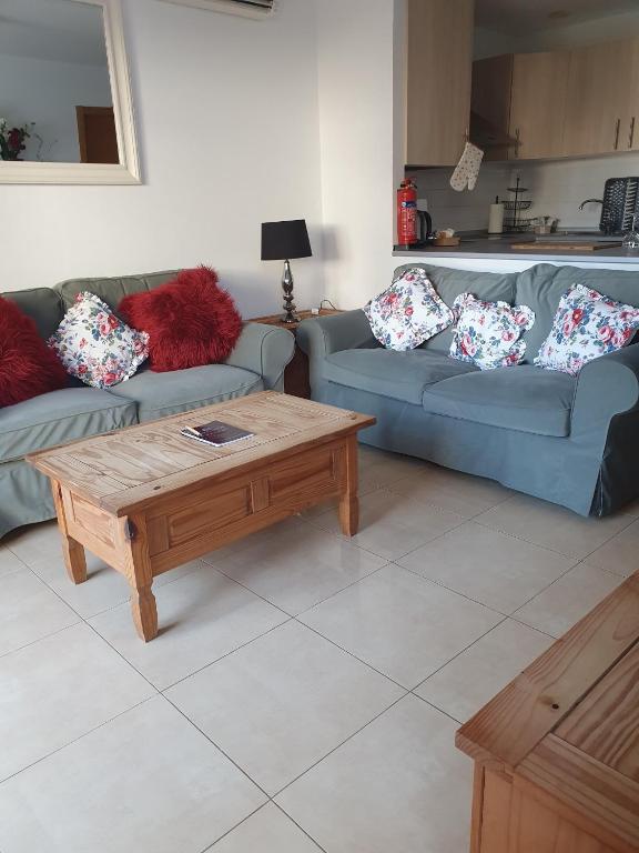 a living room with two couches and a coffee table at Spacious and peaceful apartment Jardin 2 in Alhama de Murcia