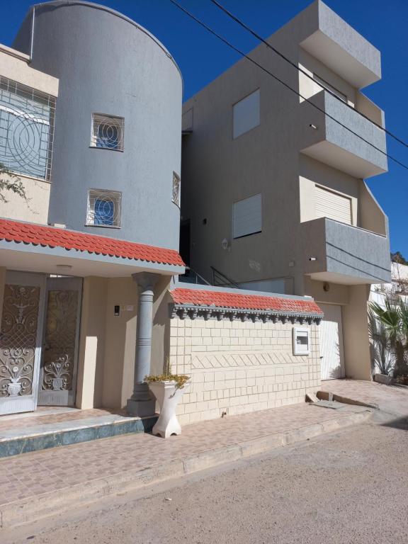a large house with a building at Dar Zina in Mteurch