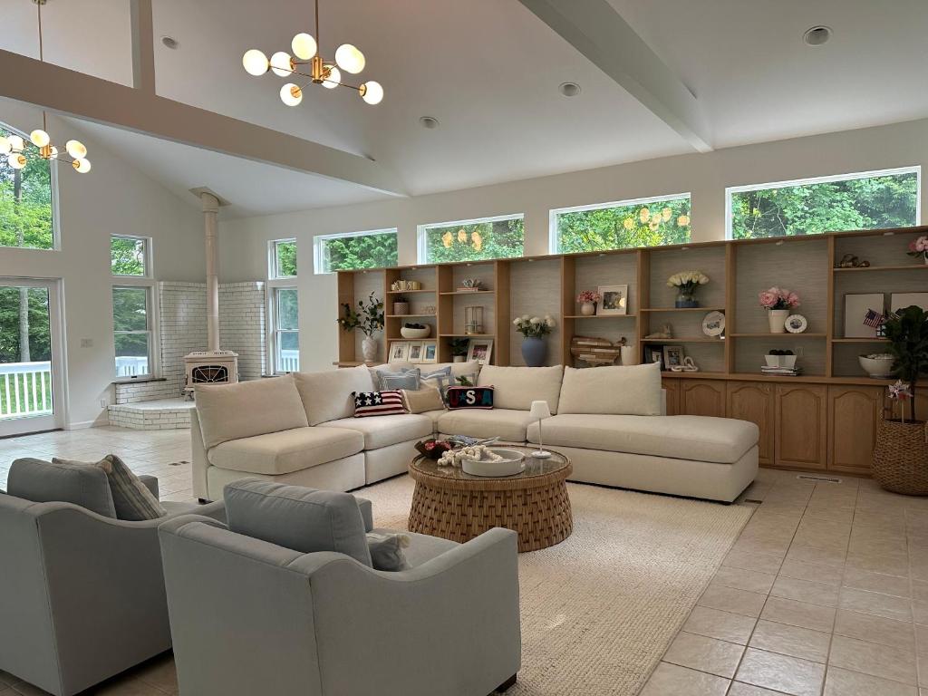 a large living room with white furniture and windows at Villa Après Sea in Westport