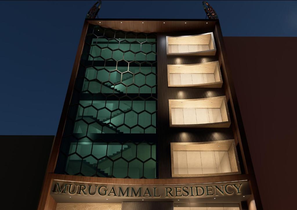 a building with a sign in front of it at Murugammal residency in Tiruppatūr