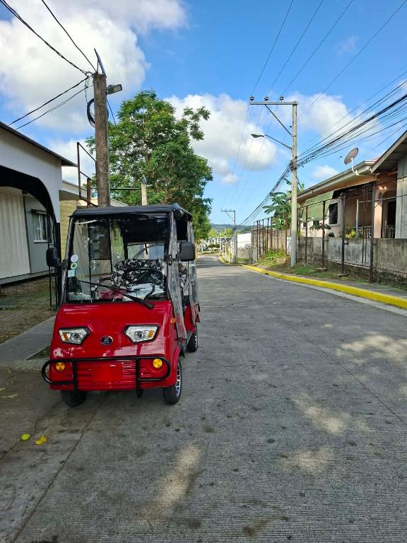 a small red golf cart parked on a street at 1 greenside Street,dianella in Muchea