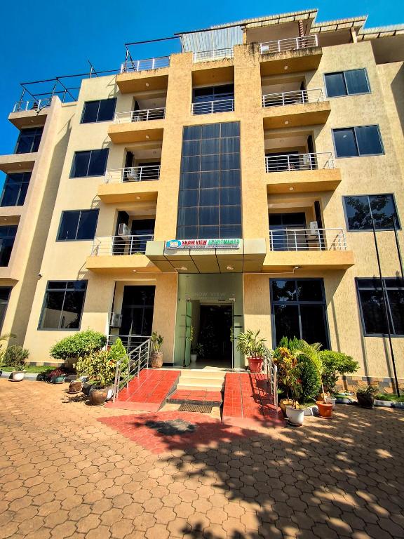 a large building with a lot of windows at Snow View Residences in Msaranga