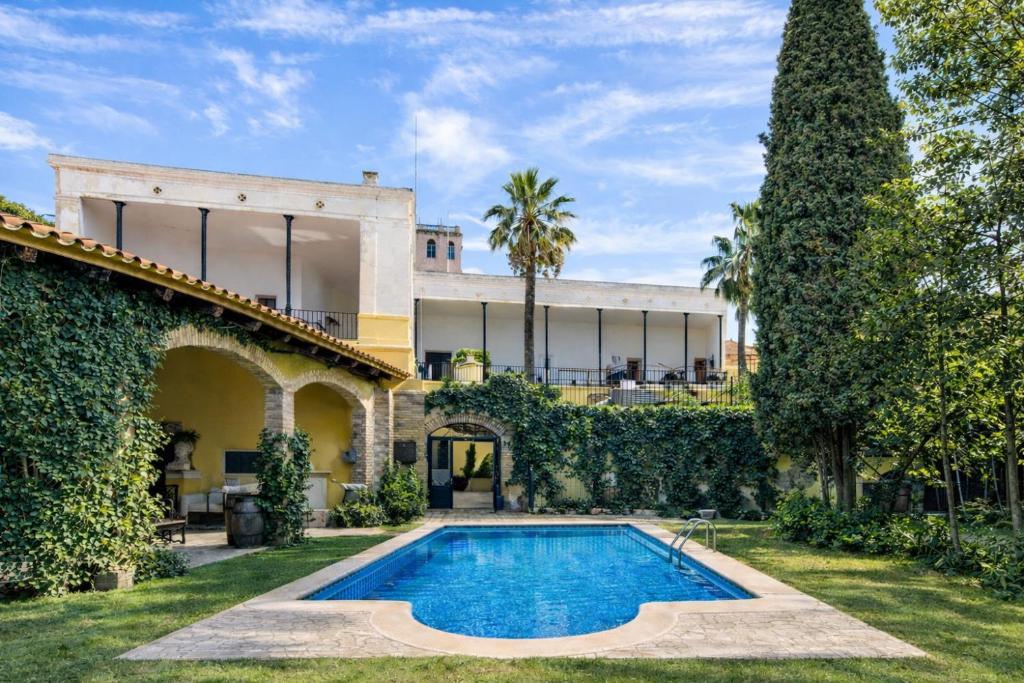 an exterior view of a house with a swimming pool at Catalunya Casas Impressive and Idyllic mansion for up to 40 people! in Banyeres del Penedes