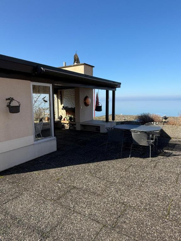 a house on the beach with a table at Urlaub am Bodensee in Staad - einmalige Seesicht in Staad