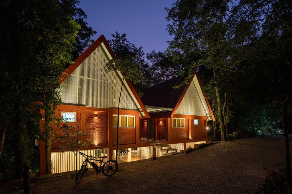a house with a bike parked in front of it at Leopard Eye Resort in Kitulgala