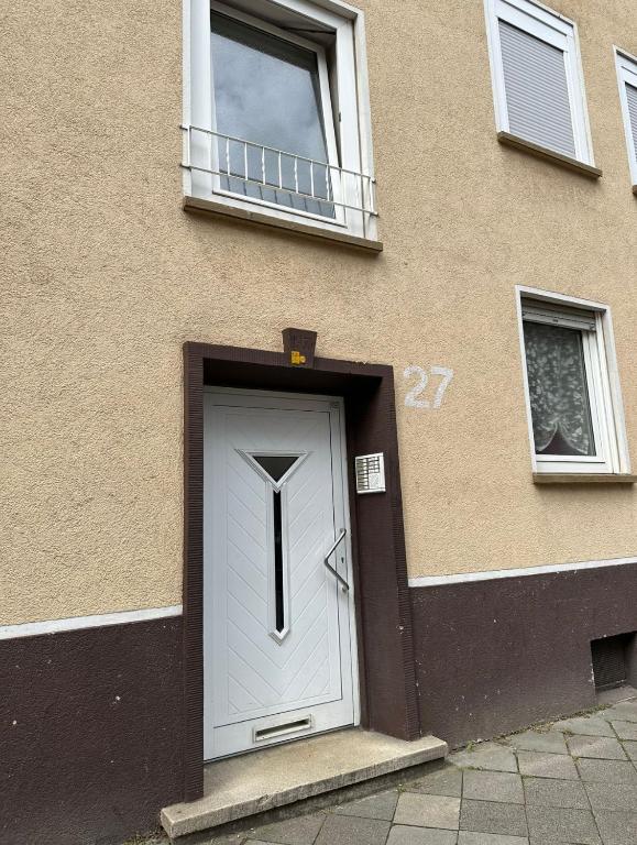 a house with a white door and two windows at Ruhige Wohnung in Gelsenkirchen in Gelsenkirchen