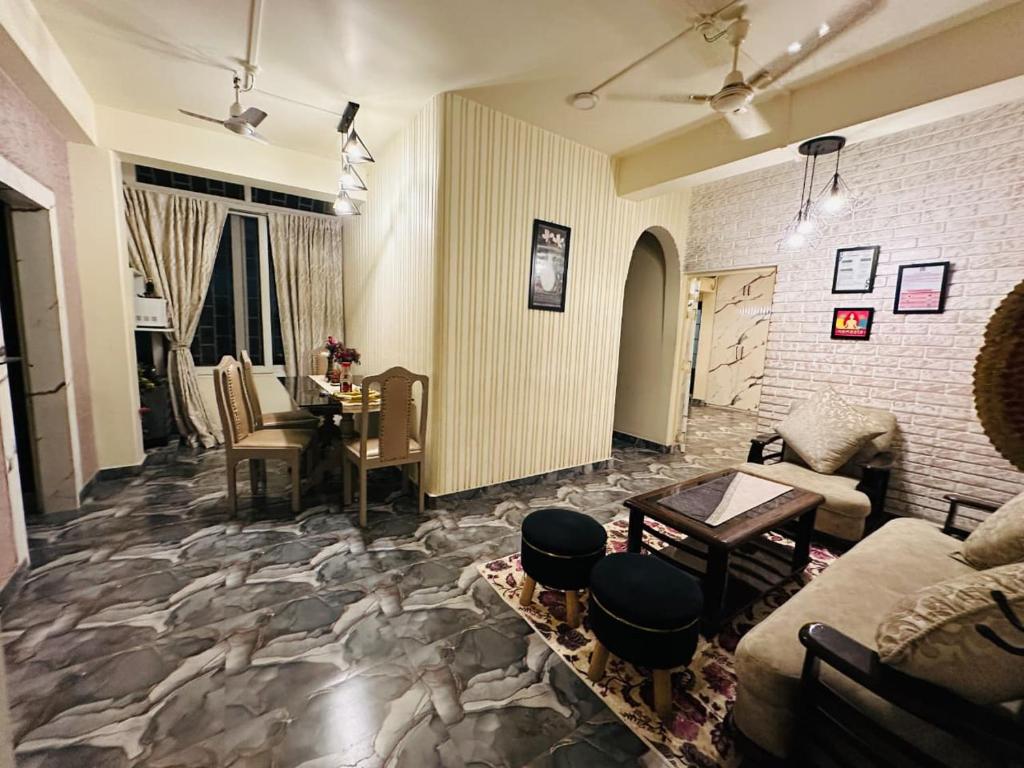 a living room with a couch and a table at Velouria Homestay in Guwahati