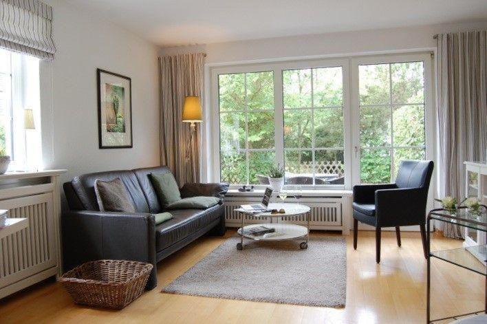 a living room with a couch and a table at Haus-Kim in Tinnum