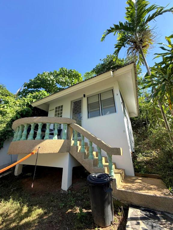 a house with a staircase in front of it at Firefly Bungalows Samui in Ban Bang Po