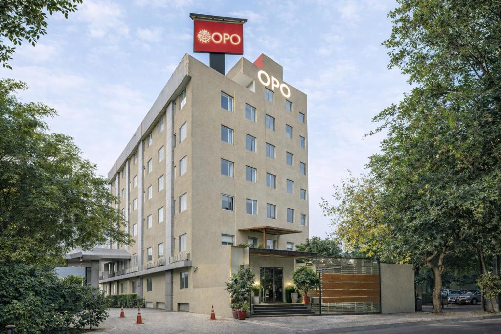 a building with a clock on top of it at OPO Horizon LYRO Hotel , Formerly known as Inde Hotel in Gurgaon