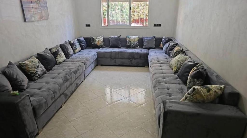 a long couch in a living room at Lune in Sidi Yahia az Zaʼer