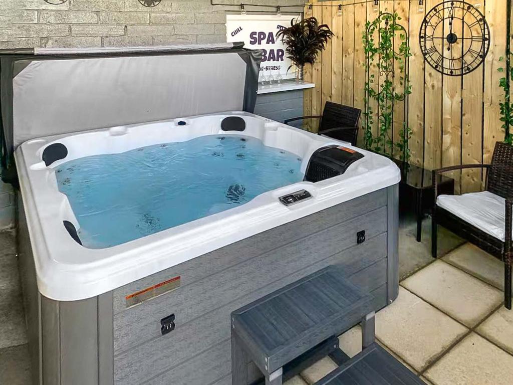 a hot tub sitting on top of a patio at Wagtail Cottage-Ukc6984 in Castleside