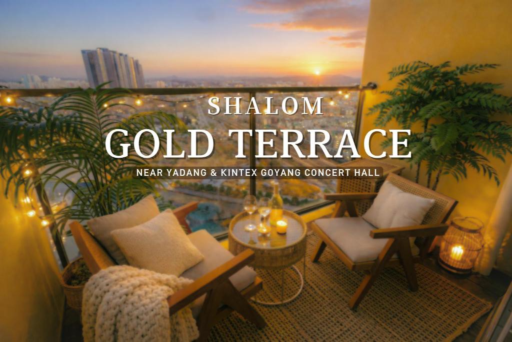 a sign for a gold terrace with chairs and a table at Shalom Gold Terrace in Paju