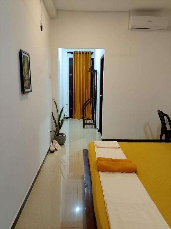 a room with two beds and a hallway with a door at Jb Villa in Bona Vista