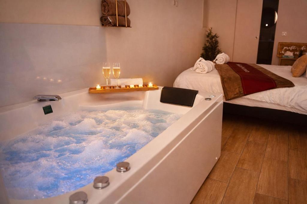 a bathtub with clouds in it in a bedroom at Perle Dazur Jacuzzi Suite Parking Prive 5min Mer in Menton