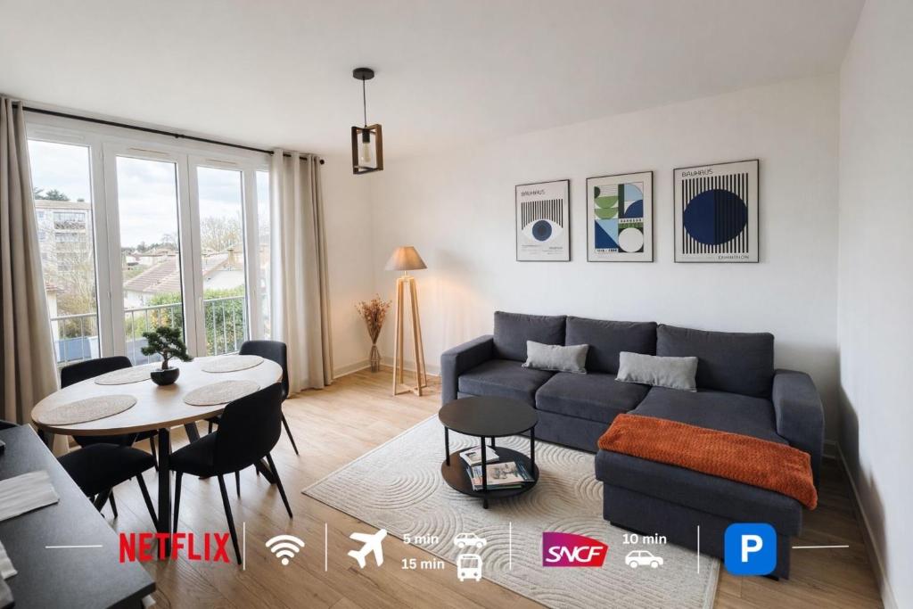 a living room with a couch and a table at Charming T2- apartment in Beauvais in Beauvais