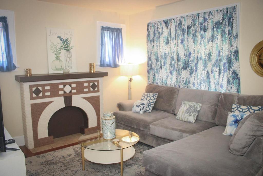 a living room with a couch and a fireplace at Charming 1 BR Apt 6 miles from Downtown! in Cincinnati