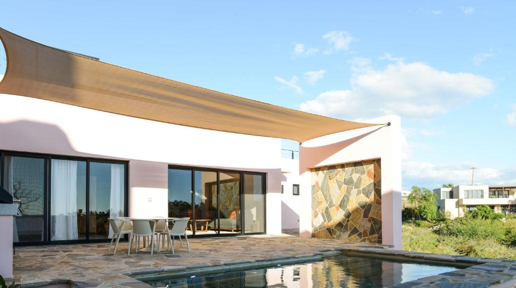 a villa with a swimming pool and a house at Casa Arroyo Pacific in Todos Santos