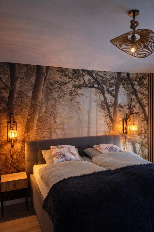 a bedroom with two beds and a wall with trees at Waldpanorama Schildberg in Lügde