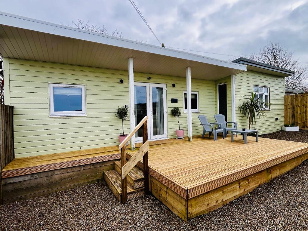 a wooden deck on the side of a house at The Cabin at Swelle Cottages in Poundstock