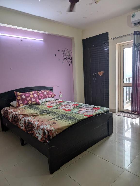 a bedroom with a large bed in a room at Panchsheel Greens 2 in Ghaziabad