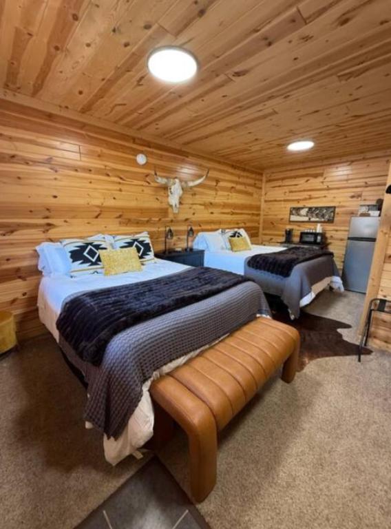 a bedroom with two beds in a log cabin at A Night In Northfield in Hixton